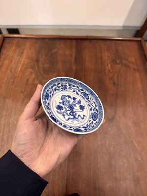Lot 54 - A Chinese Ming-style blue and white 'lotus bouquet' saucer, Qing dynasty, Daoguang mark and of the period