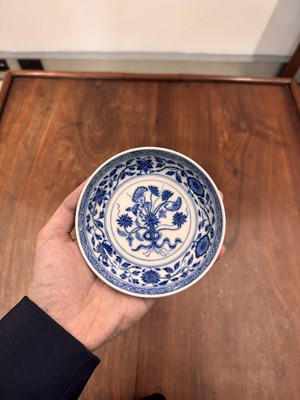 Lot 54 - A Chinese Ming-style blue and white 'lotus bouquet' saucer, Qing dynasty, Daoguang mark and of the period