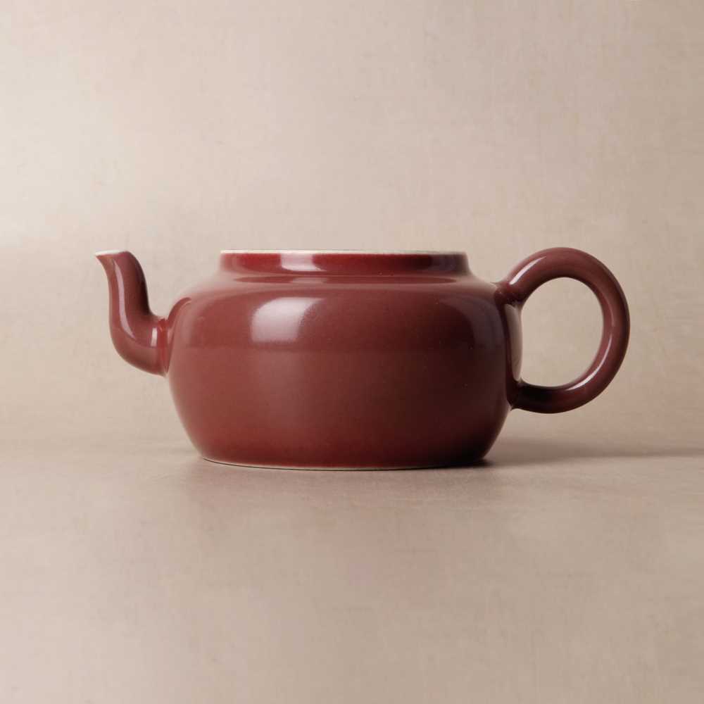 Lot 48 - A Chinese monochrome copper-red teapot, Yongzheng mark and possibly of the period