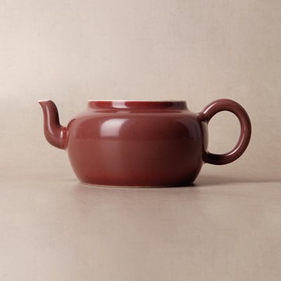 Lot 48 - A Chinese monochrome copper-red teapot, Yongzheng mark and possibly of the period
