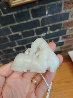 Lot 509 - A Chinese white jade 'horses' carving, late Qing dynasty