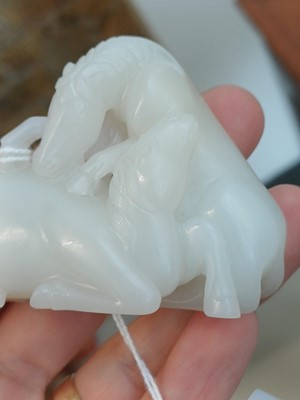 Lot 509 - A Chinese white jade 'horses' carving, late Qing dynasty