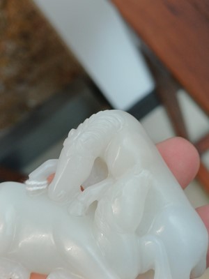 Lot 509 - A Chinese white jade 'horses' carving, late Qing dynasty