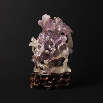 Lot 136 - A Chinese amethyst 'birds and peach' carving, Qing dynasty, 19th century