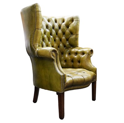 Lot 16 - A George III style green leather wing armchair