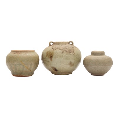 Lot 692 - A group of three celadon-glazed jars, Ming dynasty