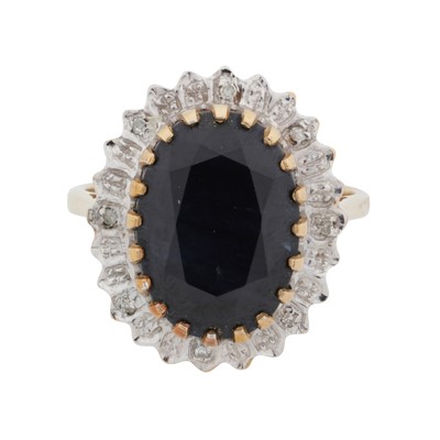 Lot 9 - A sapphire and diamond halo ring