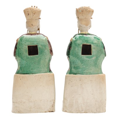 Lot 25 - A pair of Chinese sancai-glazed biscuit 'court official' figures, Qing dynasty, Kangxi period