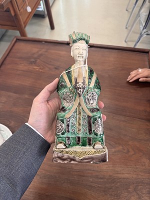 Lot 25 - A pair of Chinese sancai-glazed biscuit 'court official' figures, Qing dynasty, Kangxi period