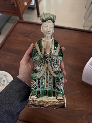 Lot 25 - A pair of Chinese sancai-glazed biscuit 'court official' figures, Qing dynasty, Kangxi period