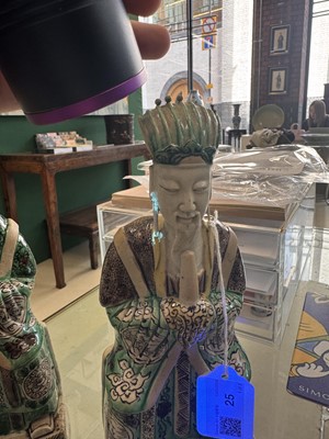 Lot 25 - A pair of Chinese sancai-glazed biscuit 'court official' figures, Qing dynasty, Kangxi period