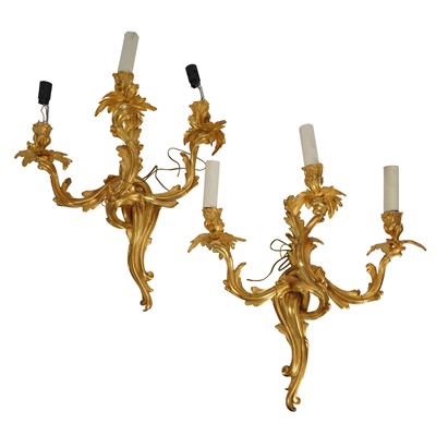 Lot 287 - A pair of gilt metal three light wall appliques in the Louis XV style, 20th century