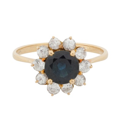 Lot 4 - A sapphire and white paste halo ring
