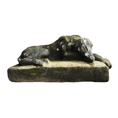 Lot 90 - A reconstituted stone model of a recumbent hound, 20th century