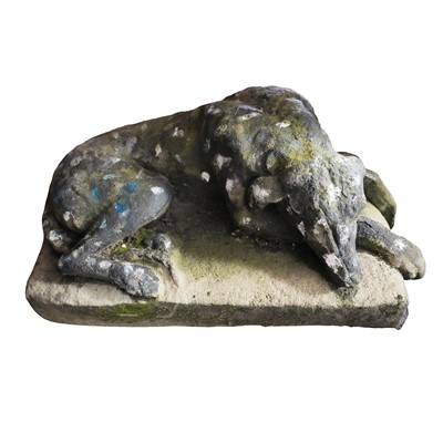 Lot 90 - A reconstituted stone model of a recumbent hound, 20th century