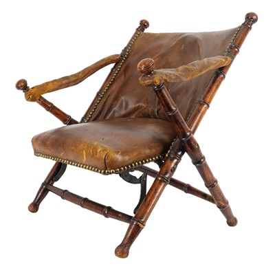 Lot 47 - In the manner of Maison Jansen, a French child's folding campaign chair