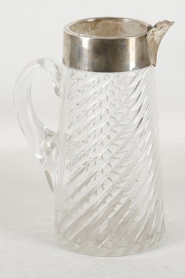 Lot 309 - A tall fluted glass jug having a deep...