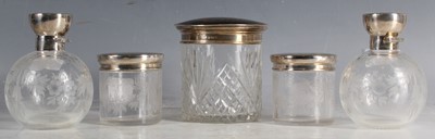 Lot 25 - A set of four wheel engraved glass cosmetic...