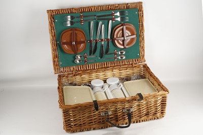 Lot 556 - An early 1970's wicker picnic hamper, four...