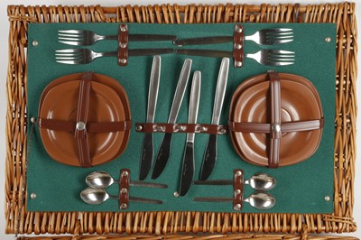 Lot 556 - An early 1970's wicker picnic hamper, four...