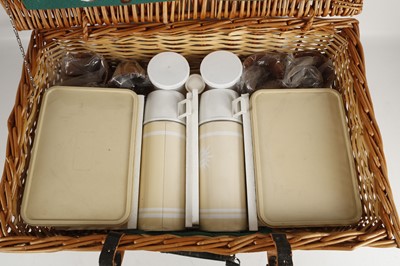 Lot 556 - An early 1970's wicker picnic hamper, four...