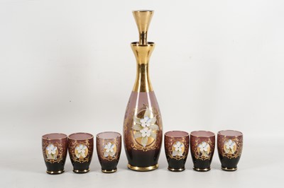 Lot 552 - An amethyst glass decanter and six shot...