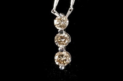 Lot 579 - An 18ct white gold and diamond three stone...