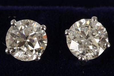 Lot 580 - A pair of 18ct white gold and diamond studs,...