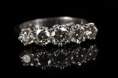 Lot 621 - An 18ct white gold and graduated five stone...