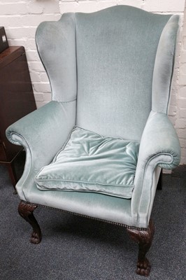 Lot 827 - A green upholstered Georgian style wing...