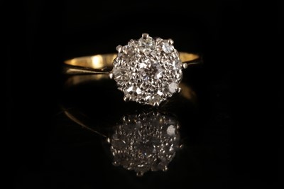Lot 591 - An 18ct gold and diamond set floral cluster ring.