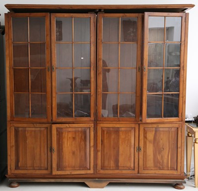 Lot 827 - A Yew library bookcase, with four glazed doors,...