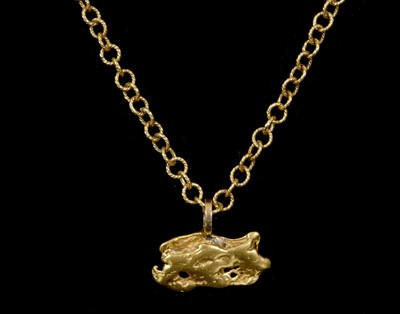 Lot 670 - A pure Gold Nugget pendant, suspended from a...