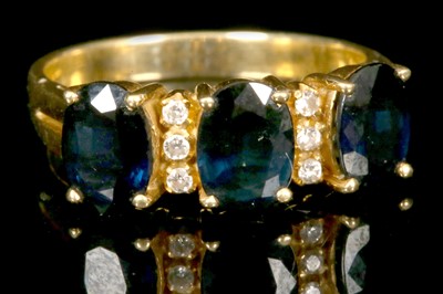 Lot 236 - An 18ct gold, sapphire and diamond set ring....