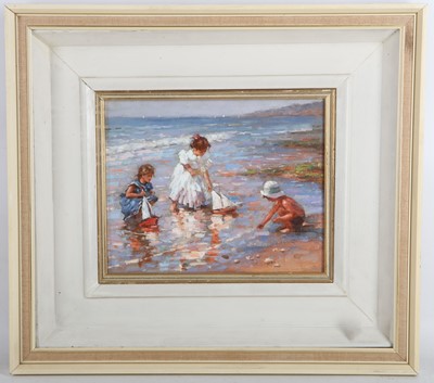 Lot 53 - An oil painting beach scene with children and...