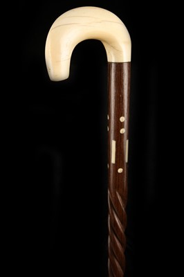 Lot 112 - AN IVORY HANDLED WALKING CANE, the hook grip...