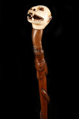 Lot 120 - A MARINE IVORY GROTESQUE HEAD CANE, the carved...