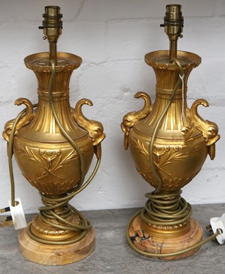 Lot 188 - A pair of gilt metal lamp bases, with dolphin...