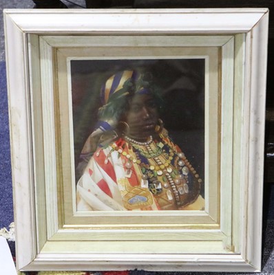 Lot 110 - An oil painted portrait of an African woman...