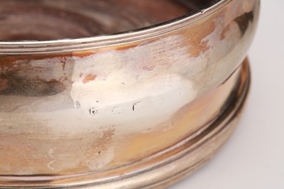 Lot 598 - Two antique sterling silver wine coaster, one...