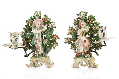 Lot 302 - A PAIR OF BOW PORCELAIN CANDLESTICK FIGURES OF...