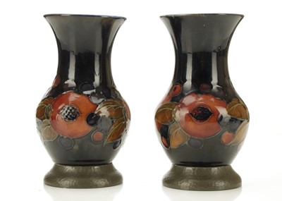 Lot 425 - A PAIR OF WALTER MOORCROFT PEWTER-MOUNTED...