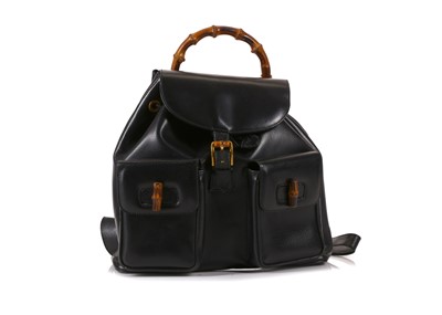 Lot 446 - Gucci black leather and bamboo backpack, two...