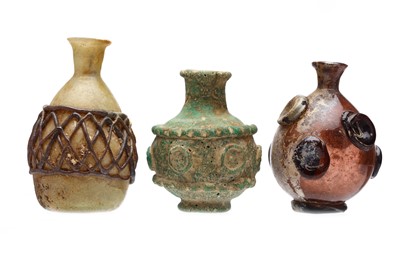 Lot 3 - THREE UMAYYAD OR EASTERN IRANIAN GLASS FLASKS,...