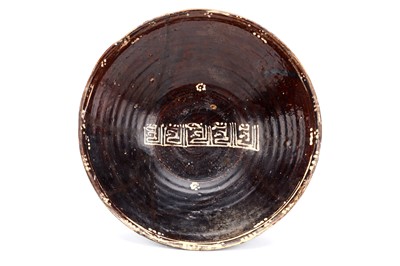 Lot 13 - A LARGE NISHAPUR BROWN GLAZED CERAMIC BOWL,...