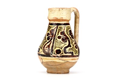 Lot 18 - A NISHAPUR GLAZED CERAMIC JUG, decorated with...