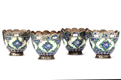 Lot 100 - FOUR PERSIAN QAJAR SILVER CUPS, with blue and...