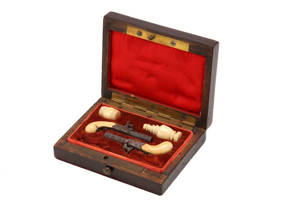 Lot 111 - A 19th century cased miniature pistols set The...