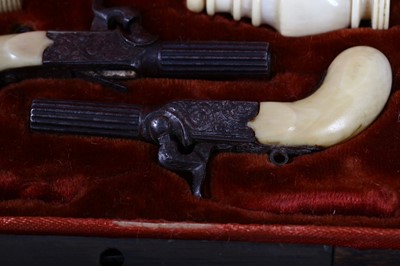 Lot 111 - A 19th century cased miniature pistols set The...