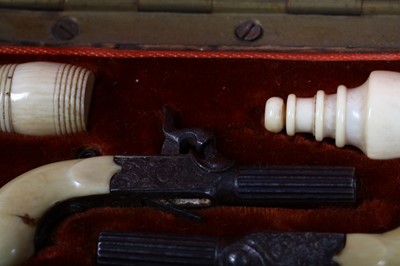 Lot 111 - A 19th century cased miniature pistols set The...